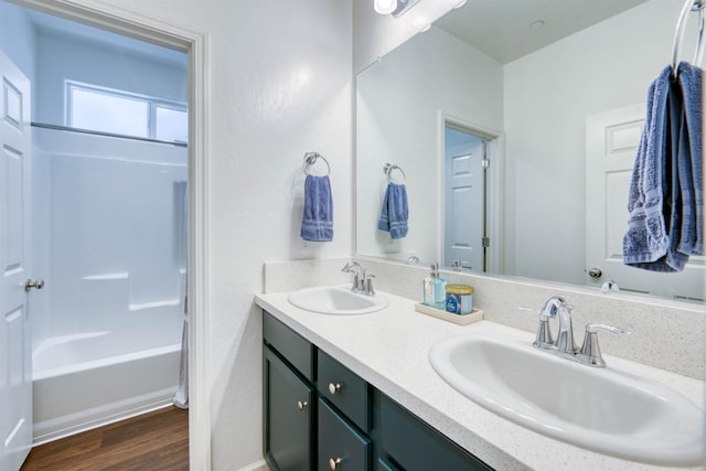 6659 E Vassar Ave, Fresno, CA 93727 - bathroom featuring double vanity, wood finished floors, and bathing tub / shower combination