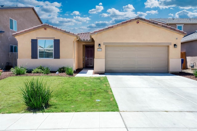 6659 E Vassar Ave, Fresno, CA 93727 - mediterranean / spanish house with stucco siding, a garage, a front lawn, concrete driveway, and a tile roof