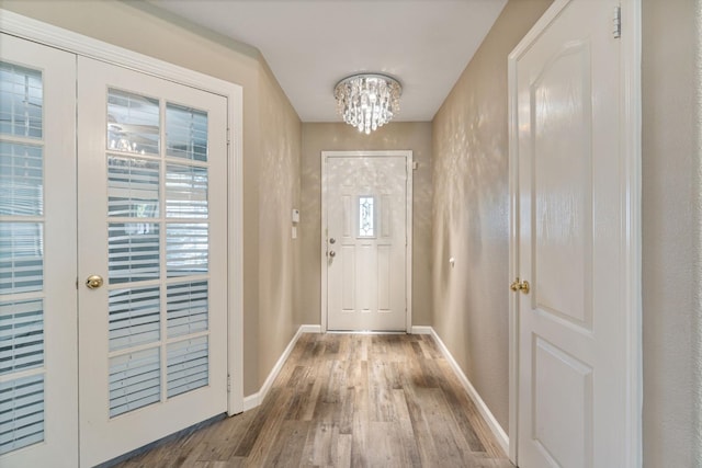 10131 N Price Ave, Fresno, CA 93730 - entryway with wood finished floors, a chandelier, and baseboards