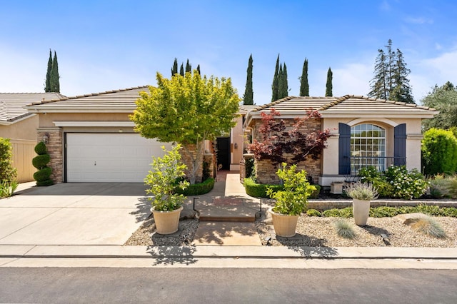 2189 W Via Delfini, Fresno, CA 93711 - view of front facade featuring stucco siding, concrete driveway, a garage, and a tiled roof