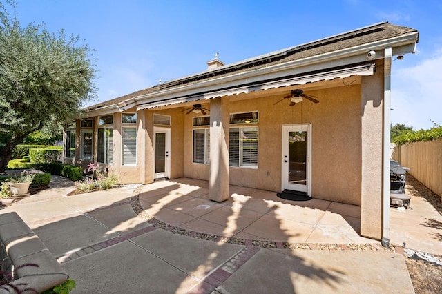 2189 W Via Delfini, Fresno, CA 93711 - back of property featuring ceiling fan, stucco siding, a patio, and solar panels