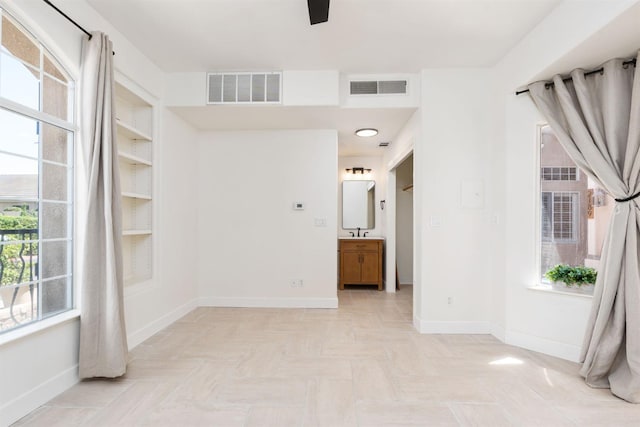 2189 W Via Delfini, Fresno, CA 93711 - spare room with baseboards and a sink