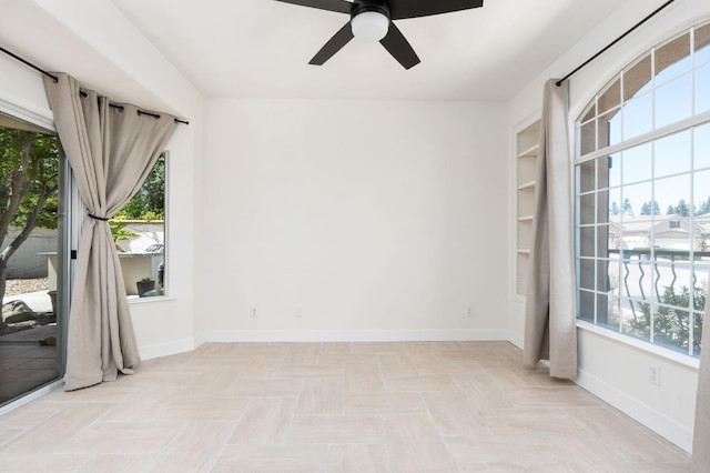 2189 W Via Delfini, Fresno, CA 93711 - empty room with plenty of natural light, a ceiling fan, and baseboards