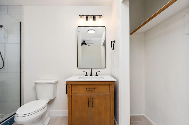 2189 W Via Delfini, Fresno, CA 93711 - bathroom with toilet, vanity, a tile shower, baseboards, and a ceiling fan