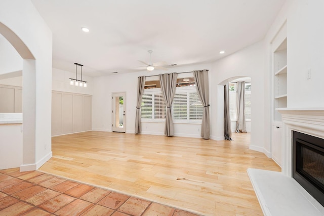 2189 W Via Delfini, Fresno, CA 93711 - unfurnished living room featuring arched walkways, built in features, a ceiling fan, light wood-type flooring, and recessed lighting