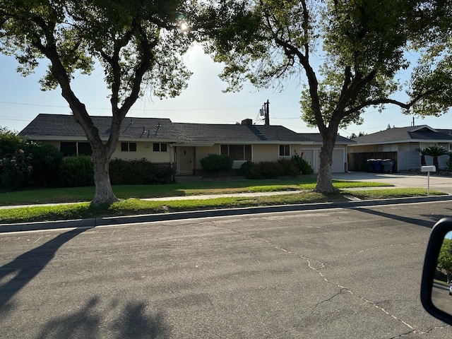 5655 N Poplar Ave, Fresno, CA 93704 - ranch-style home featuring concrete driveway and a garage