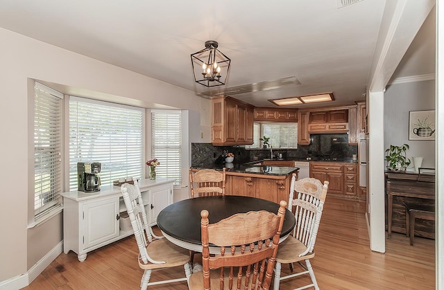 311 S Fowler Ave, Fowler, CA 93625 - dining room featuring light wood-style floors, baseboards, a chandelier, and ornamental molding