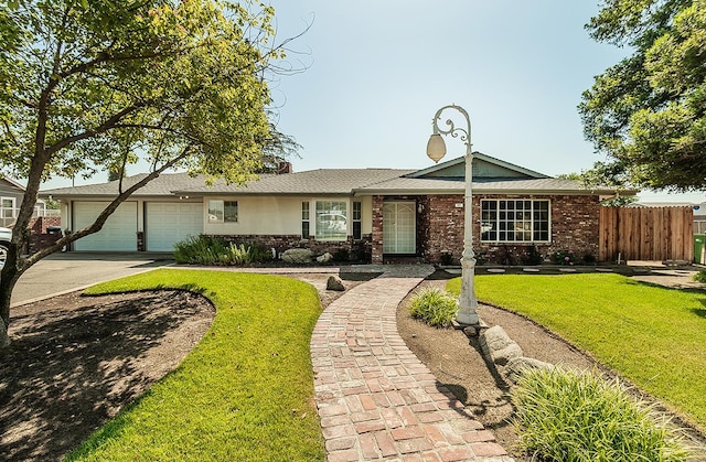 311 S Fowler Ave, Fowler, CA 93625 - single story home with a garage, driveway, and brick siding