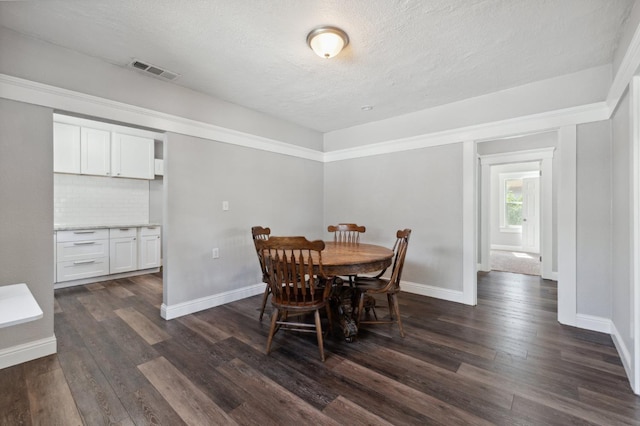 4112 E Platt Ave, Fresno, CA 93702 - dining space with dark wood finished floors, baseboards, and a textured ceiling