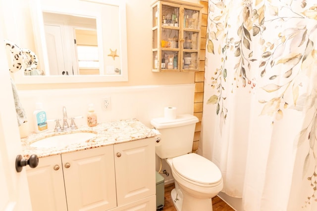 101 S Princeton Ave, Coalinga, CA 93210 - full bath with vanity, toilet, curtained shower, and wood finished floors
