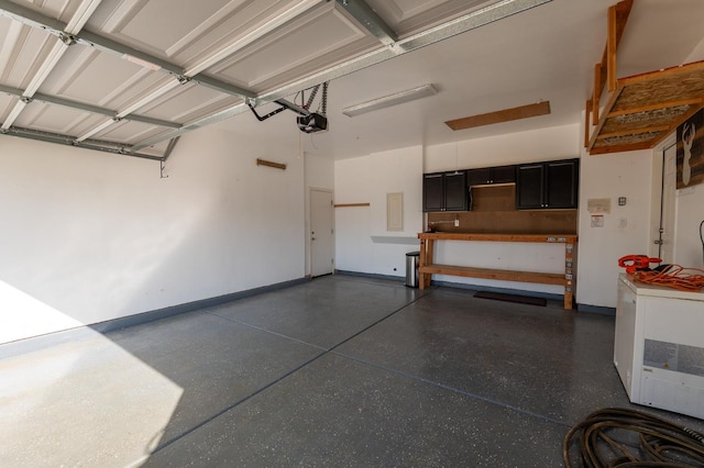 3083 N Stanley Ave, Fresno, CA 93737 - garage with a garage door opener, electric panel, and baseboards