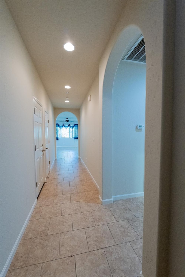 3083 N Stanley Ave, Fresno, CA 93737 - corridor featuring arched walkways, recessed lighting, and baseboards