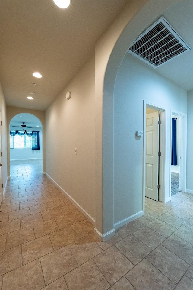 3083 N Stanley Ave, Fresno, CA 93737 - hall featuring arched walkways, recessed lighting, and baseboards