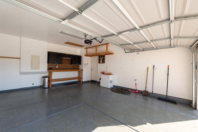 3083 N Stanley Ave, Fresno, CA 93737 - garage featuring baseboards and a garage door opener
