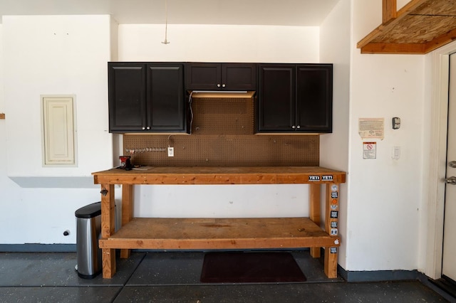 3083 N Stanley Ave, Fresno, CA 93737 - kitchen featuring backsplash, dark cabinetry, and baseboards