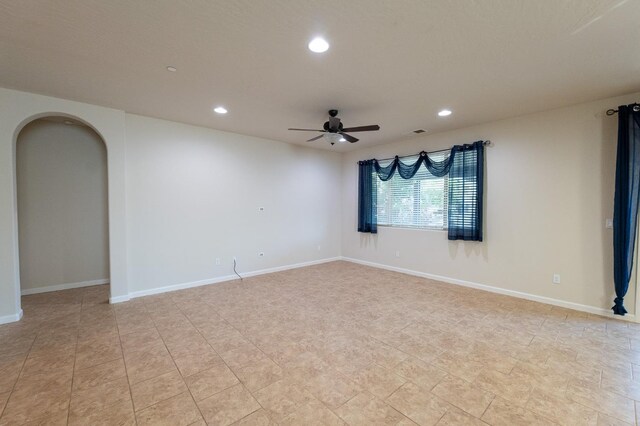 3083 N Stanley Ave, Fresno, CA 93737 - spare room featuring a ceiling fan, recessed lighting, arched walkways, baseboards, and light tile patterned floors