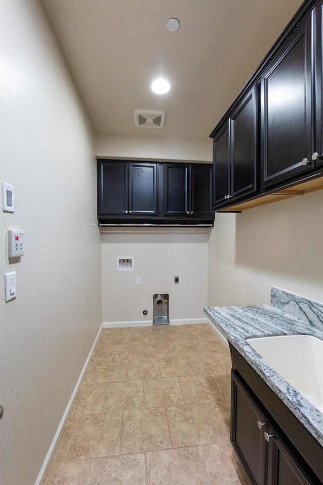 3083 N Stanley Ave, Fresno, CA 93737 - washroom featuring electric dryer hookup, washer hookup, cabinet space, gas dryer hookup, and baseboards