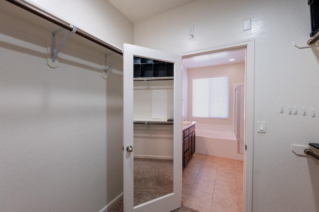 3083 N Stanley Ave, Fresno, CA 93737 - walk in closet featuring light tile patterned flooring