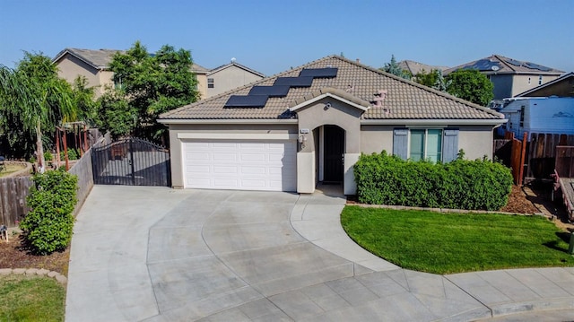 3083 N Stanley Ave, Fresno, CA 93737 - mediterranean / spanish home with driveway, an attached garage, stucco siding, and a gate