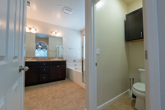 3083 N Stanley Ave, Fresno, CA 93737 - full bath with double vanity, tiled tub, toilet, and plenty of natural light