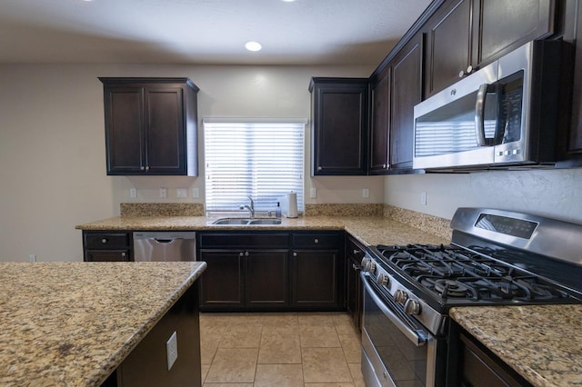 3083 N Stanley Ave, Fresno, CA 93737 - kitchen with stainless steel appliances, a sink, healthy amount of natural light, and light stone counters