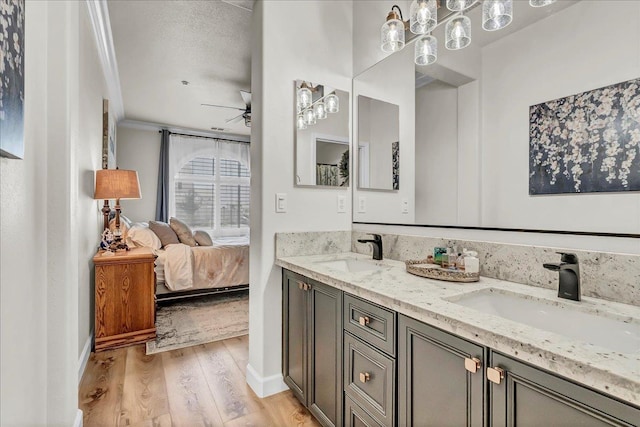 1281 W Walter Ave Unit 15, Fowler, CA 93625 - full bathroom with wood finished floors, double vanity, ceiling fan, crown molding, and connected bathroom