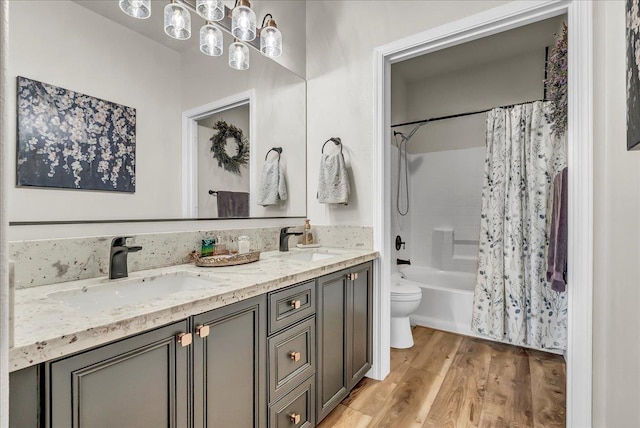 1281 W Walter Ave Unit 15, Fowler, CA 93625 - full bath featuring toilet, wood finished floors, shower / tub combo with curtain, and double vanity