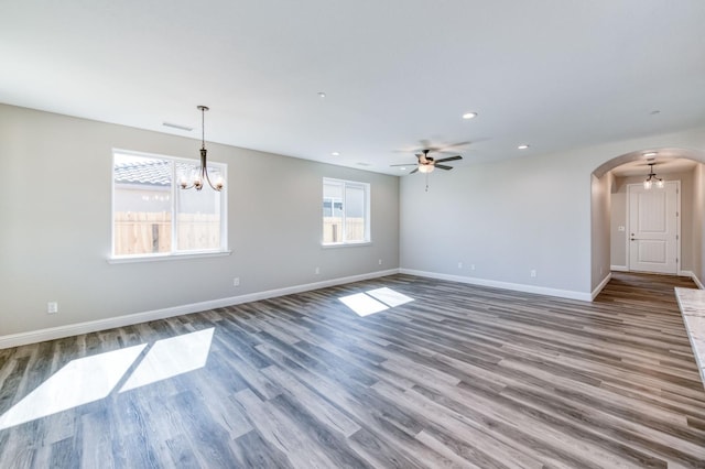 957 S Koleen Ave, Kerman, CA 93630 - spare room with arched walkways, recessed lighting, a ceiling fan, wood finished floors, and a chandelier