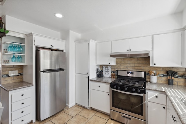 2316 S Kirk St, Fresno, CA 93706 - kitchen with appliances with stainless steel finishes, under cabinet range hood, tasteful backsplash, white cabinets, and light tile patterned flooring