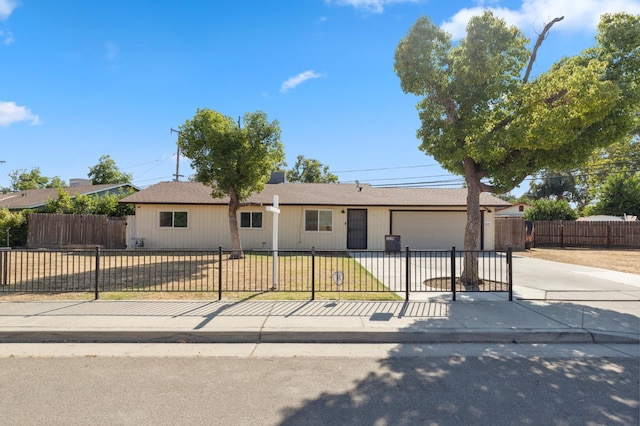2316 S Kirk St, Fresno, CA 93706 - ranch-style home with driveway, a garage, a fenced front yard, and roof with shingles