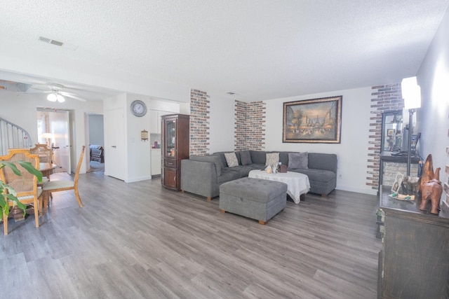 92 W Sierra Unit 104, Fresno, CA 93704 - living room with wood finished floors, a textured ceiling, and ceiling fan
