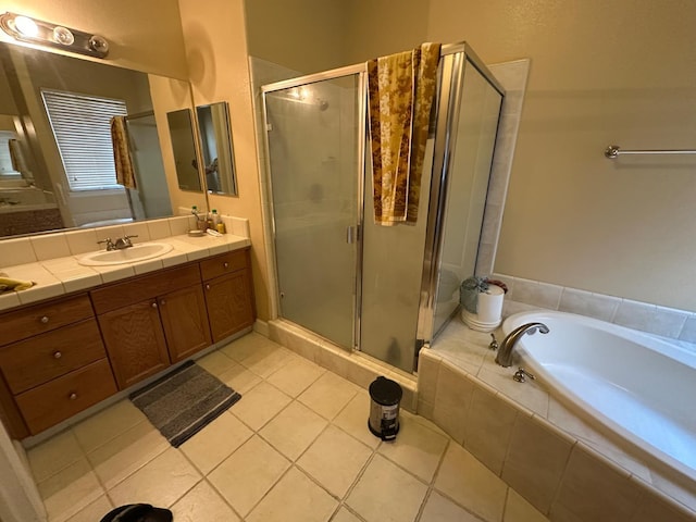 5804 W Chennault Ave, Fresno, CA 93722 - full bathroom with vanity, a stall shower, a bath, and tile patterned floors