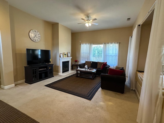 5804 W Chennault Ave, Fresno, CA 93722 - living area featuring carpet floors, ceiling fan, baseboards, and a glass covered fireplace