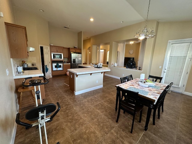 5804 W Chennault Ave, Fresno, CA 93722 - dining space with a chandelier, baseboards, high vaulted ceiling, and dark tile patterned flooring