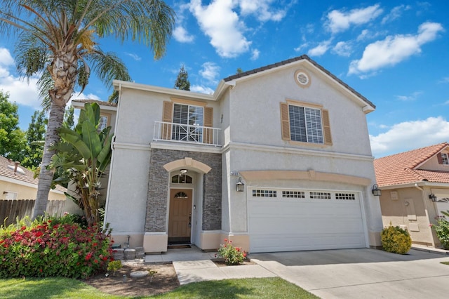 6481 N Alison Ln, Fresno, CA 93711 - view of front of property featuring a balcony, stone siding, an attached garage, and stucco siding