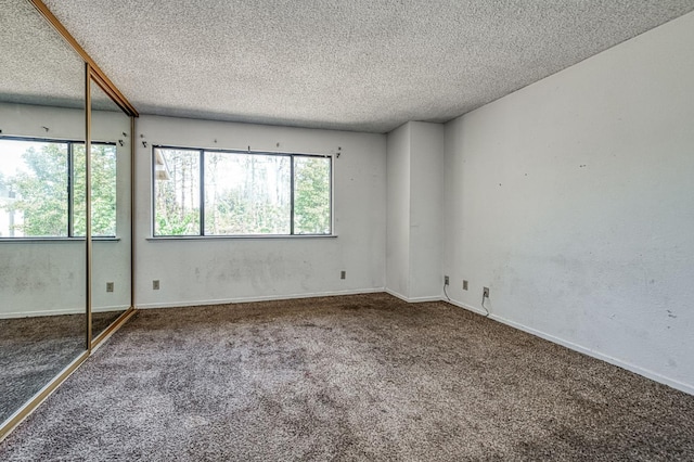 4885 N Backer Ave Unit 151, Fresno, CA 93726 - unfurnished bedroom featuring carpet flooring, a textured ceiling, a closet, and baseboards