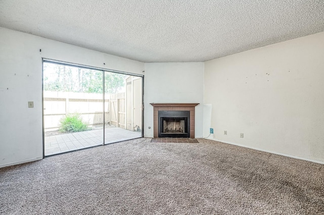 4885 N Backer Ave Unit 151, Fresno, CA 93726 - unfurnished living room with carpet flooring, a textured ceiling, a tile fireplace, and baseboards