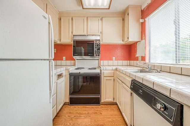 4885 N Backer Ave Unit 151, Fresno, CA 93726 - kitchen featuring white appliances, tile countertops, plenty of natural light, and a sink