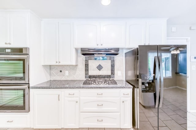 3171 W Sample Ave, Fresno, CA 93711 - kitchen featuring appliances with stainless steel finishes, exhaust hood, stone counters, and backsplash