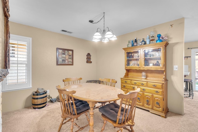 5072 N Forkner Ave, Fresno, CA 93711 - dining space with light carpet, healthy amount of natural light, and a chandelier