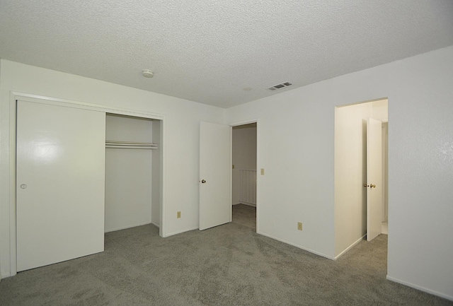4779 N Cedar Ave # 109, Fresno, CA 93726 - unfurnished bedroom featuring carpet, a closet, a textured ceiling, and baseboards