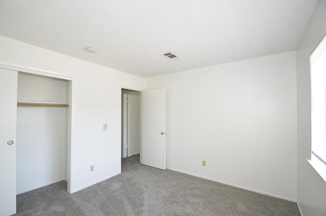 4779 N Cedar Ave # 109, Fresno, CA 93726 - unfurnished bedroom featuring carpet floors, a closet, and a textured ceiling