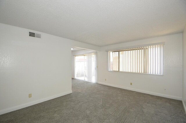 4779 N Cedar Ave # 109, Fresno, CA 93726 - empty room with a textured ceiling, carpet floors, and baseboards