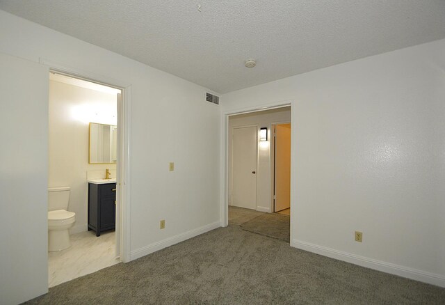 4779 N Cedar Ave # 109, Fresno, CA 93726 - unfurnished bedroom featuring carpet flooring, ensuite bathroom, and baseboards