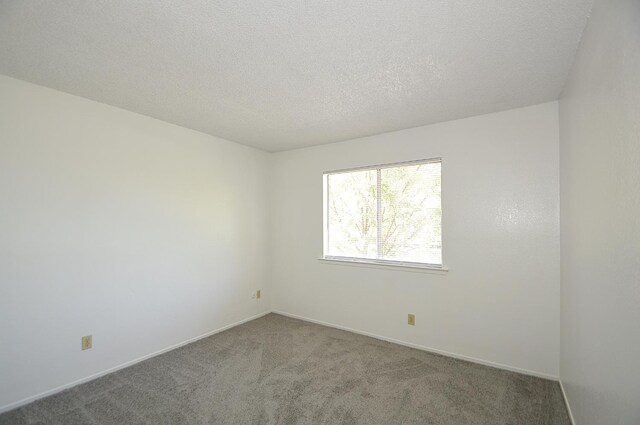 4779 N Cedar Ave # 109, Fresno, CA 93726 - spare room featuring carpet flooring, baseboards, and a textured ceiling