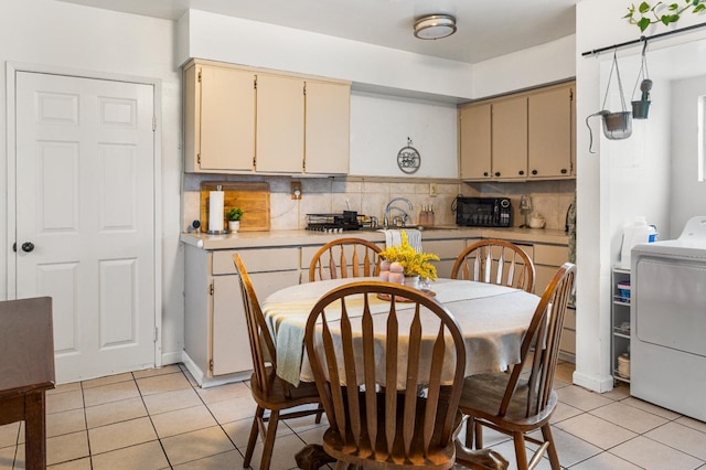 1586 N Calaveras St, Fresno, CA 93728 - kitchen with light tile patterned floors, light countertops, tasteful backsplash, cream cabinets, and black microwave