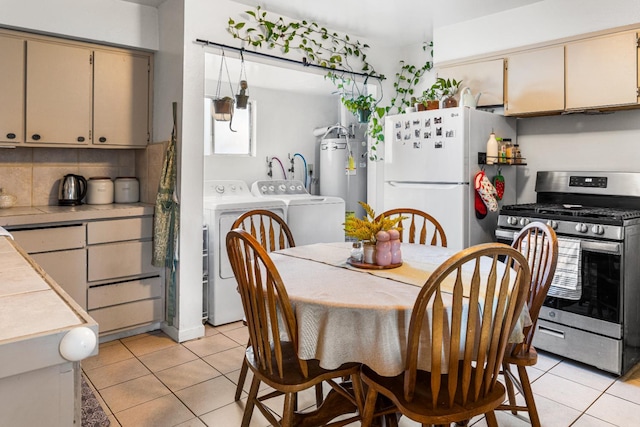 1586 N Calaveras St, Fresno, CA 93728 - dining room with washing machine and dryer, light tile patterned flooring, and water heater