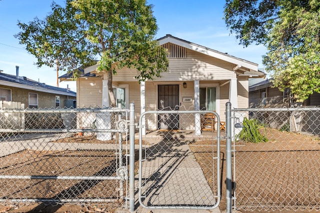 1586 N Calaveras St, Fresno, CA 93728 - view of front of house with a porch, a gate, and a fenced front yard