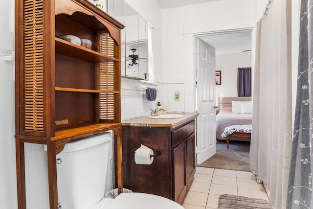 1586 N Calaveras St, Fresno, CA 93728 - bathroom with tile patterned flooring, vanity, toilet, and a ceiling fan