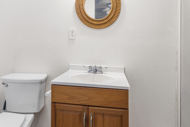 1586 N Calaveras St, Fresno, CA 93728 - bathroom with toilet, vanity, and a textured wall